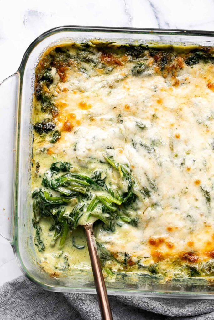 Spinach gratin is a rich and creamy side dish with a layer of crispy melty cheese on top. This fancy side is easy to make ahead and freezer-friendly. | aheadofthyme.com