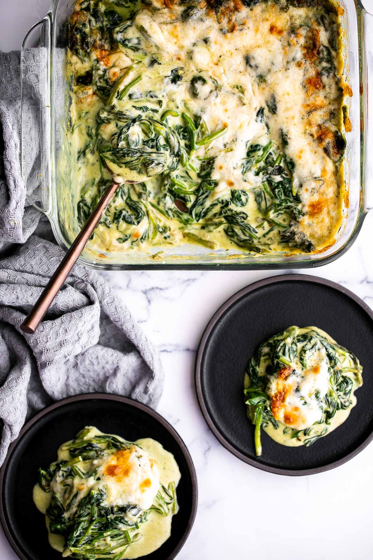 Spinach gratin is a rich and creamy side dish with a layer of crispy melty cheese on top. This fancy side is easy to make ahead and freezer-friendly. | aheadofthyme.com