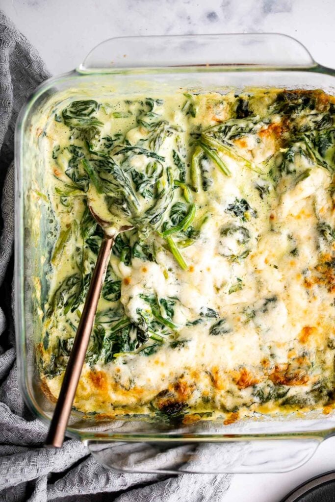 Spinach gratin is a rich and creamy side dish with a layer of crispy melty cheese on top. This fancy side is easy to make ahead and freezer-friendly. | aheadofthyme.com