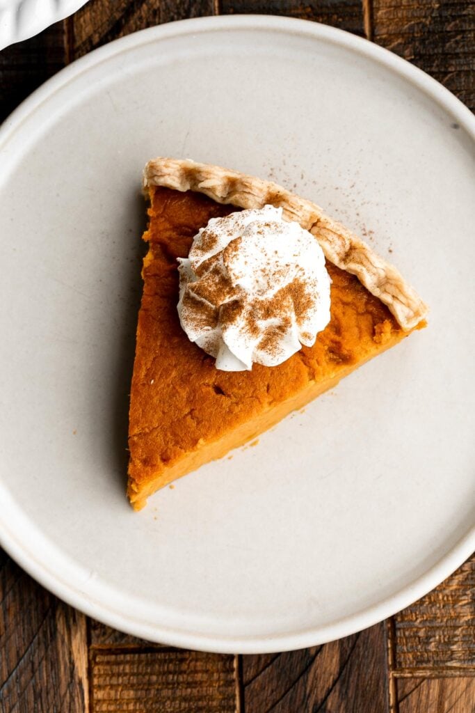 Sweet potato pie is warm and cozy, spiced with classic fall flavors, and delicious. Easy to make with cooked sweet potatoes or canned sweet potato puree. | aheadofthyme.com