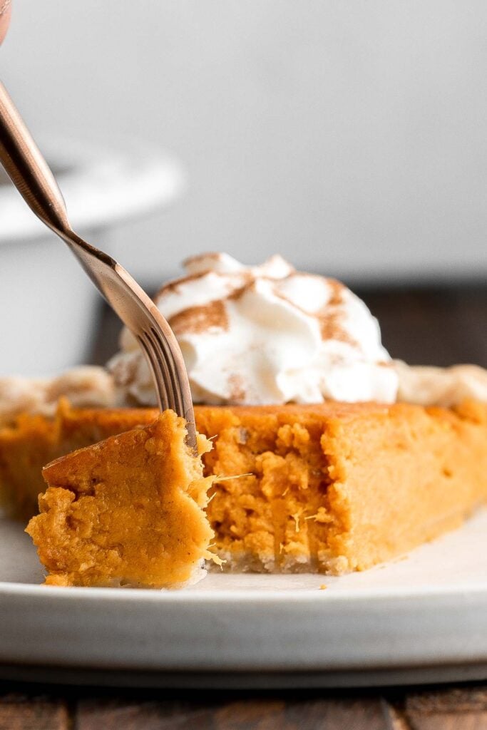 Sweet potato pie is warm and cozy, spiced with classic fall flavors, and delicious. Easy to make with cooked sweet potatoes or canned sweet potato puree. | aheadofthyme.com