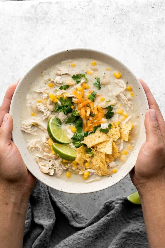 White chicken chili is an easy and delicious one pot meal made with shredded chicken, hearty veggies, and a creamy broth that's loaded with flavor. | aheadofthyme.com