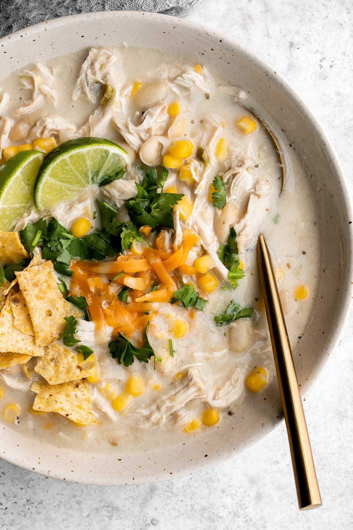 White chicken chili is an easy and delicious one pot meal made with shredded chicken, hearty veggies, and a creamy broth that's loaded with flavor. | aheadofthyme.com