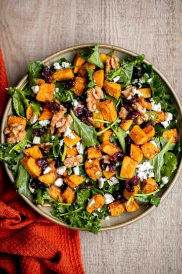 Butternut Squash Salad is a fresh and cozy fall salad with roasted squash, kale, walnuts, cranberries, and feta tossed in lemon dressing. Perfect for fall. | aheadofthyme.com