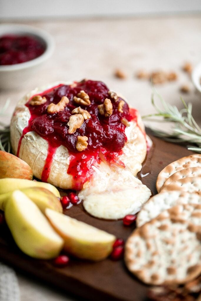 Cranberry baked brie is a sweet and savory appetizer you need to try this holiday season. It's quick and easy, melty and gooey, and so delicious. | aheadofthyme.com