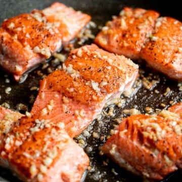 Tender, flaky, flavorful garlic butter salmon is well-seasoned, seared to perfection, and basted until juicy. Quick and easy to make in 20 minutes. | aheadofthyme.com