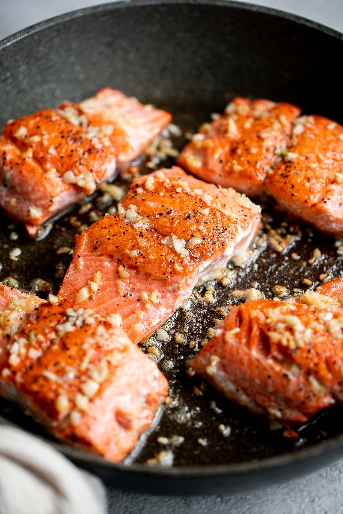 Tender, flaky, flavorful garlic butter salmon is well-seasoned, seared to perfection, and basted until juicy. Quick and easy to make in 20 minutes. | aheadofthyme.com