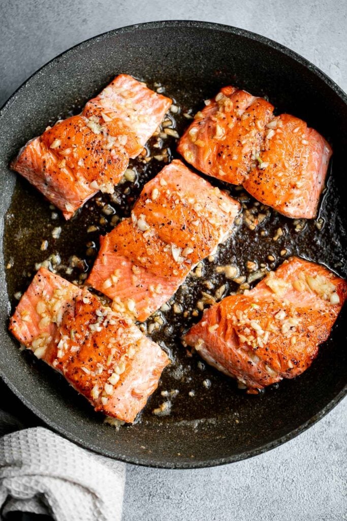 Tender, flaky, flavorful garlic butter salmon is well-seasoned, seared to perfection, and basted until juicy. Quick and easy to make in 20 minutes. | aheadofthyme.com