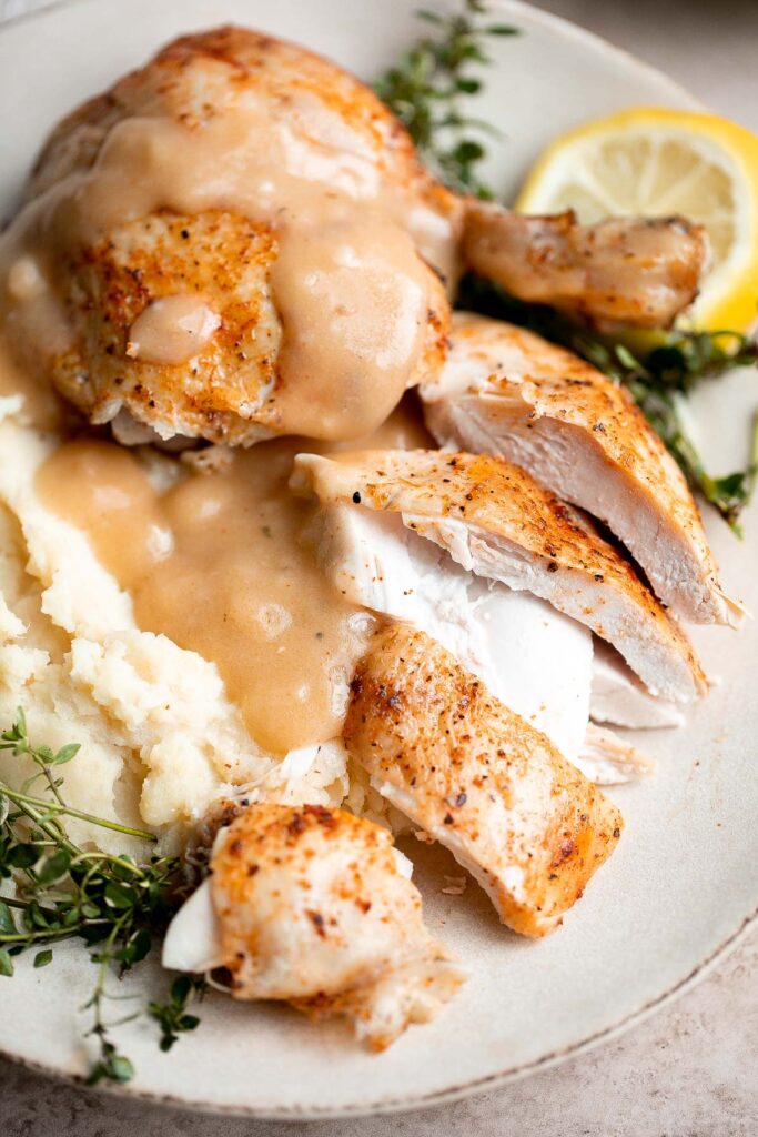 Instant pot whole chicken with gravy is tender, juicy, and flavorful. It's the fastest way to cook a whole rotisserie chicken for dinner in just 40 minutes. | aheadofthyme.com