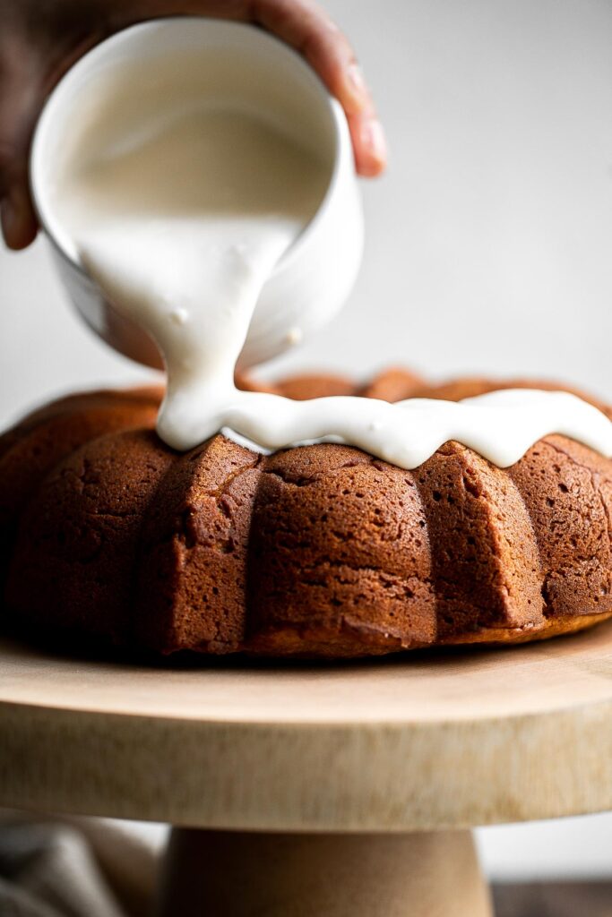 Pumpkin bundt cake with cream cheese icing is a perfect fall dessert to serve this year — super moist inside, with a perfect golden brown crumby crust. | aheadofthyme.com
