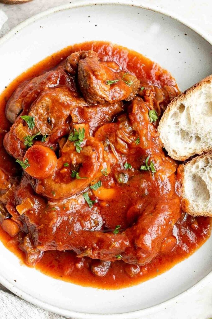 Instant pot osso buco is a delicious, classic Italian recipe with braised veal shanks stewed with vegetables in a thick, savory red wine and tomato sauce. | aheadofthyme.com