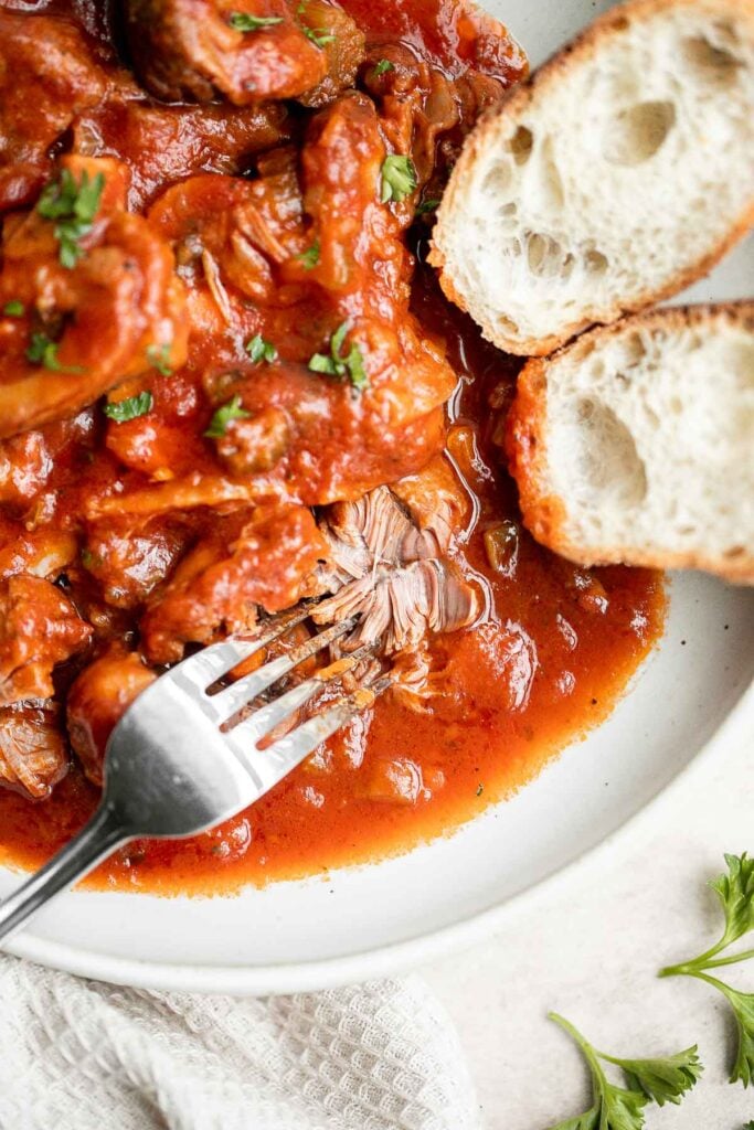 Instant pot osso buco is a delicious, classic Italian recipe with braised veal shanks stewed with vegetables in a thick, savory red wine and tomato sauce. | aheadofthyme.com