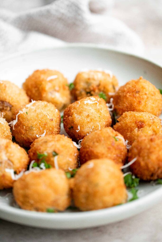 Mashed potato balls are a delicious appetizer that is crisp on the outside and soft, tender, and cheesy inside. Best way to use leftover mashed potatoes! | aheadofthyme.com