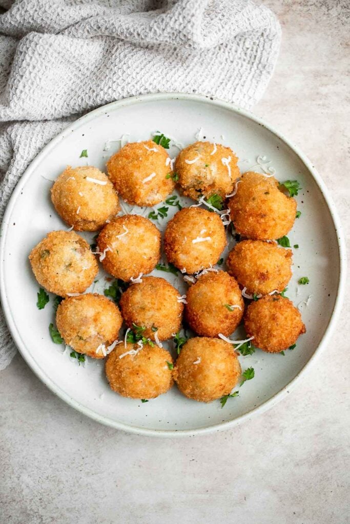 Mashed potato balls are a delicious appetizer that is crisp on the outside and soft, tender, and cheesy inside. Best way to use leftover mashed potatoes! | aheadofthyme.com