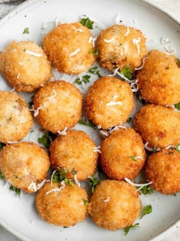 Mashed potato balls are a delicious appetizer that is crisp on the outside and soft, tender, and cheesy inside. Best way to use leftover mashed potatoes! | aheadofthyme.com