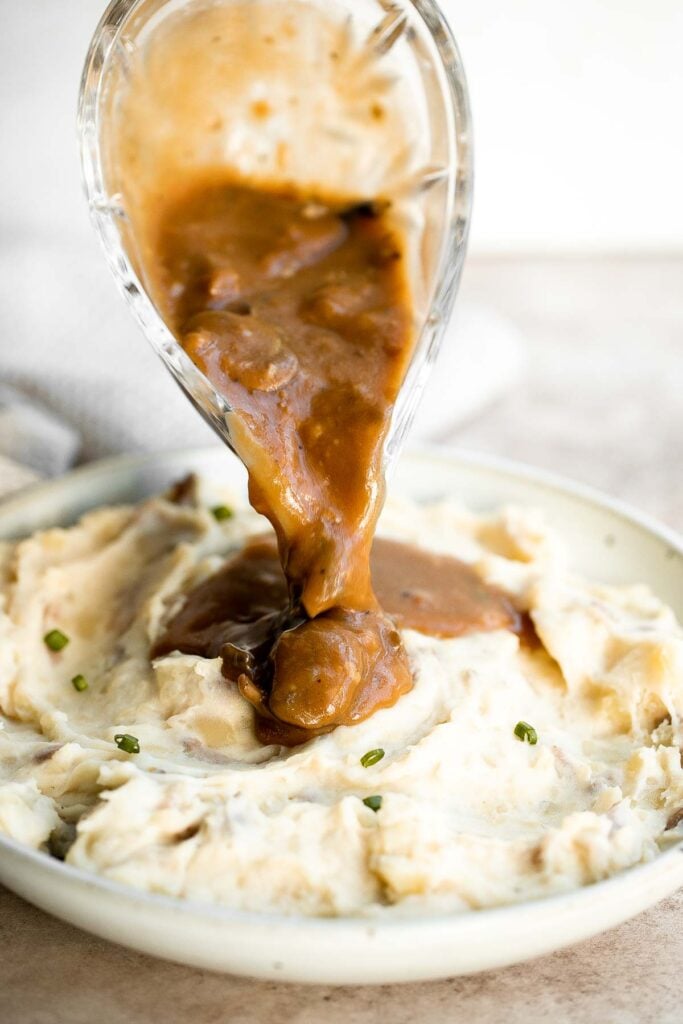 Vegetarian mushroom gravy is creamy, savory and thick, easy to make, loaded with flavor, and pairs well with everything! Make it vegan and dairy-free too. | aheadofthyme.com