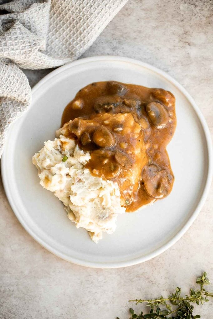 Vegetarian mushroom gravy is creamy, savory and thick, easy to make, loaded with flavor, and pairs well with everything! Make it vegan and dairy-free too. | aheadofthyme.com