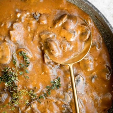 Vegetarian mushroom gravy is creamy, savory and thick, easy to make, loaded with flavor, and pairs well with everything! Make it vegan and dairy-free too. | aheadofthyme.com