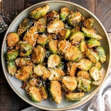 Parmesan crusted Brussels sprouts are a quick, easy, delicious side dish that's perfectly crispy outside and soft and tender inside. Ready in 30 minutes. | aheadofthyme.com