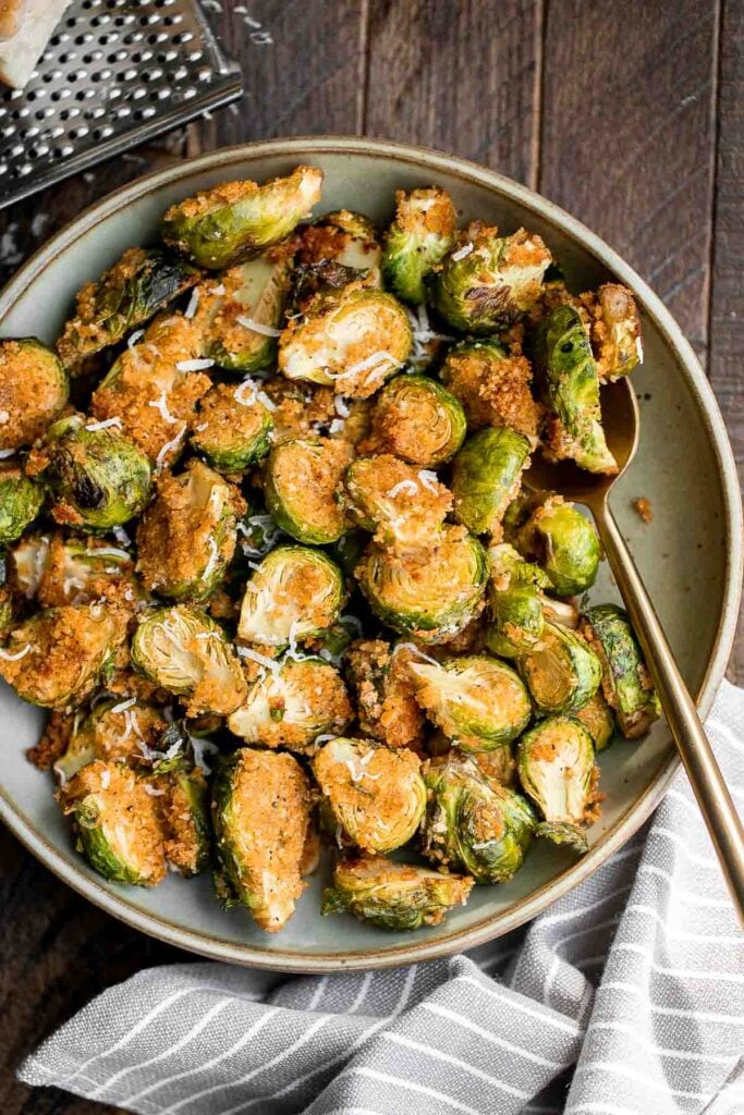 Parmesan crusted Brussels sprouts are a quick, easy, delicious side dish that's perfectly crispy outside and soft and tender inside. Ready in 30 minutes. | aheadofthyme.com