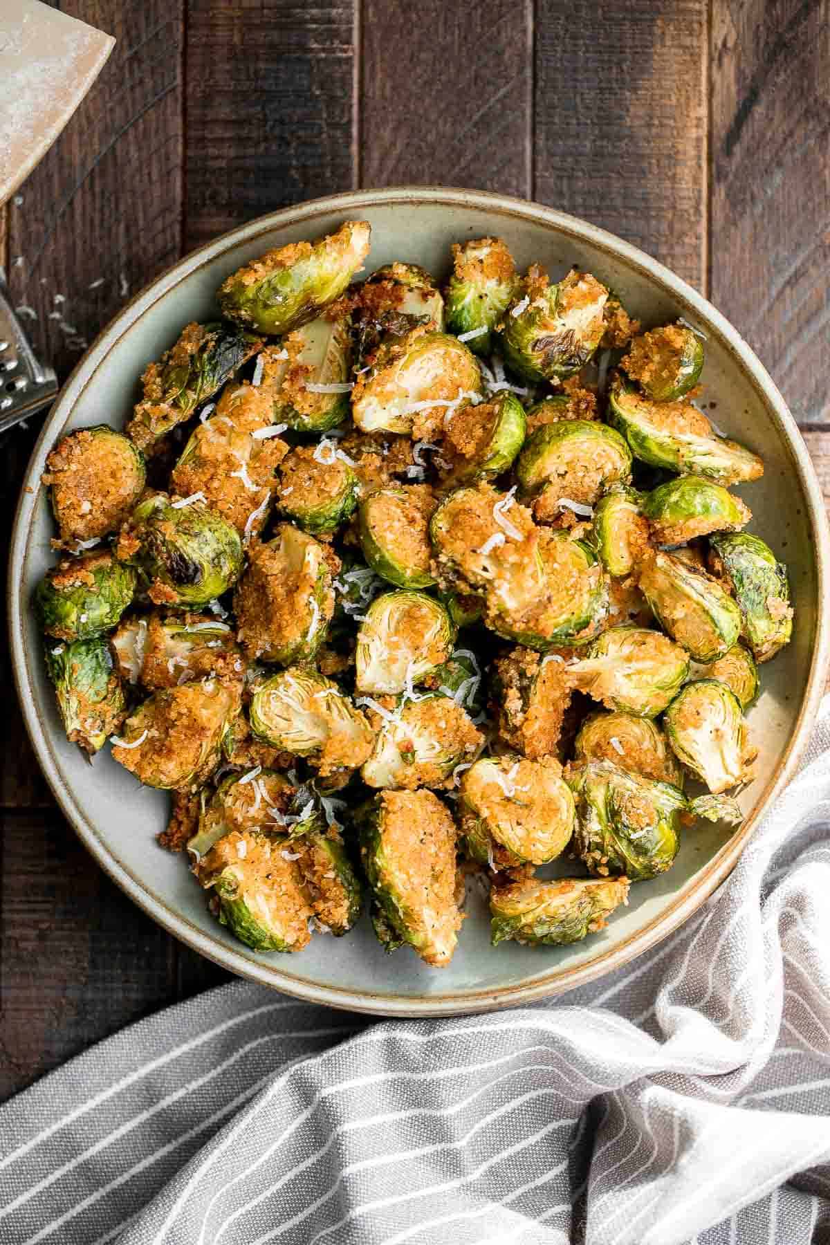 Parmesan crusted Brussels sprouts are a quick, easy, delicious side dish that's perfectly crispy outside and soft and tender inside. Ready in 30 minutes. | aheadofthyme.com