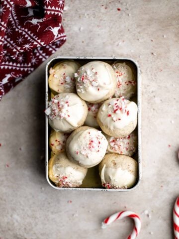 Peppermint snowball cookies are a buttery, nutty, shortbread holiday cookie that is topped with white chocolate and crushed candy canes. So festive! | aheadofthyme.com