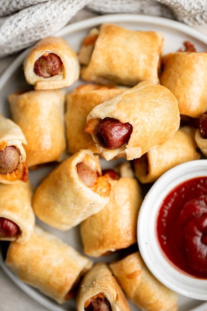 Pigs in a blanket from scratch are a delicious and easy appetizer or snack to make for your next party or gathering — juicy, cheesy, flaky, and buttery. | aheadofthyme.com