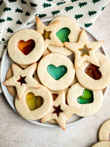 Stained glass window cookies with a soft crisp sugar cookie base and smooth jolly rancher hard candy center are the prettiest holiday cookies and easy too. | aheadofthyme.com