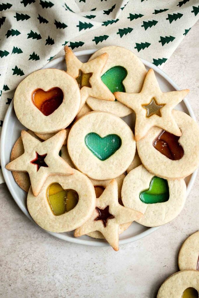 Stained glass window cookies with a soft crisp sugar cookie base and smooth jolly rancher hard candy center are the prettiest holiday cookies and easy too. | aheadofthyme.com