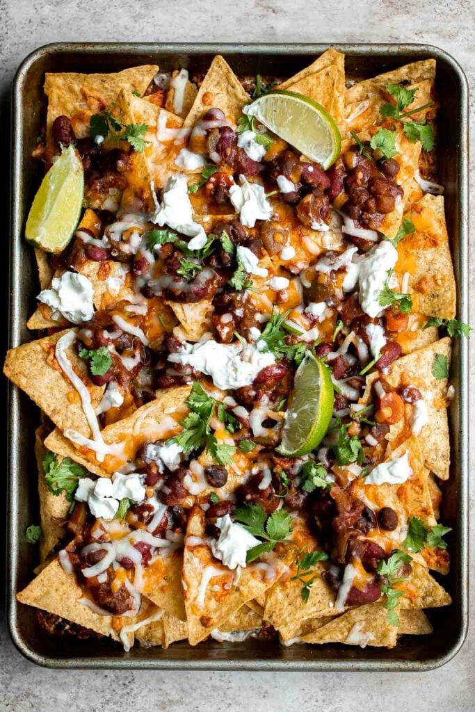 Homemade chili nachos are crispy, cheesy, delicious, and flavorful. This modern twist on a Mexican classic are the best way to use up any leftover chili. | aheadofthyme.com