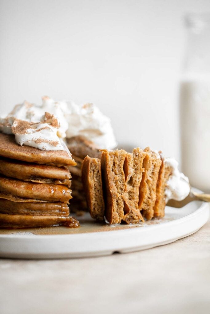 Soft and fluffy gingerbread pancakes are festive and loaded with holiday spices for the perfect breakfast on a winter morning or Christmas Day. | aheadofthyme.com