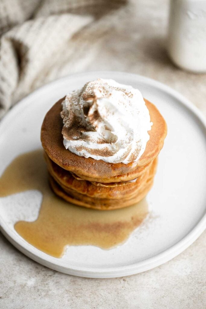 Soft and fluffy gingerbread pancakes are festive and loaded with holiday spices for the perfect breakfast on a winter morning or Christmas Day. | aheadofthyme.com