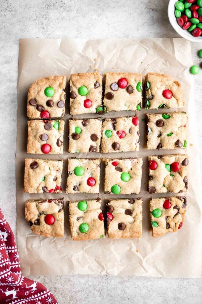 M&M cookie bars are soft and chewy, have crisp edges with a gooey center, and are loaded with M&M's and chocolate chips. The easiest way to bake cookies! | aheadofthyme.com