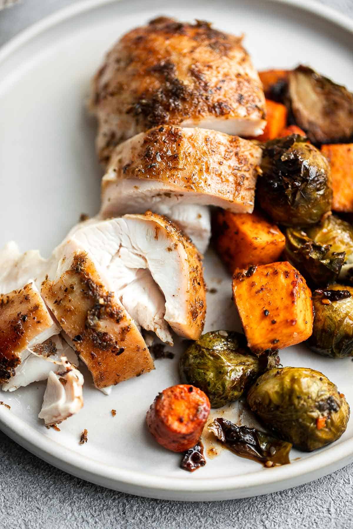 Pesto Roast Chicken is juicy, flavorful, and roasted with basil pesto over vegetables for an easy, one-pan dinner everyone loves. | aheadofthyme.com