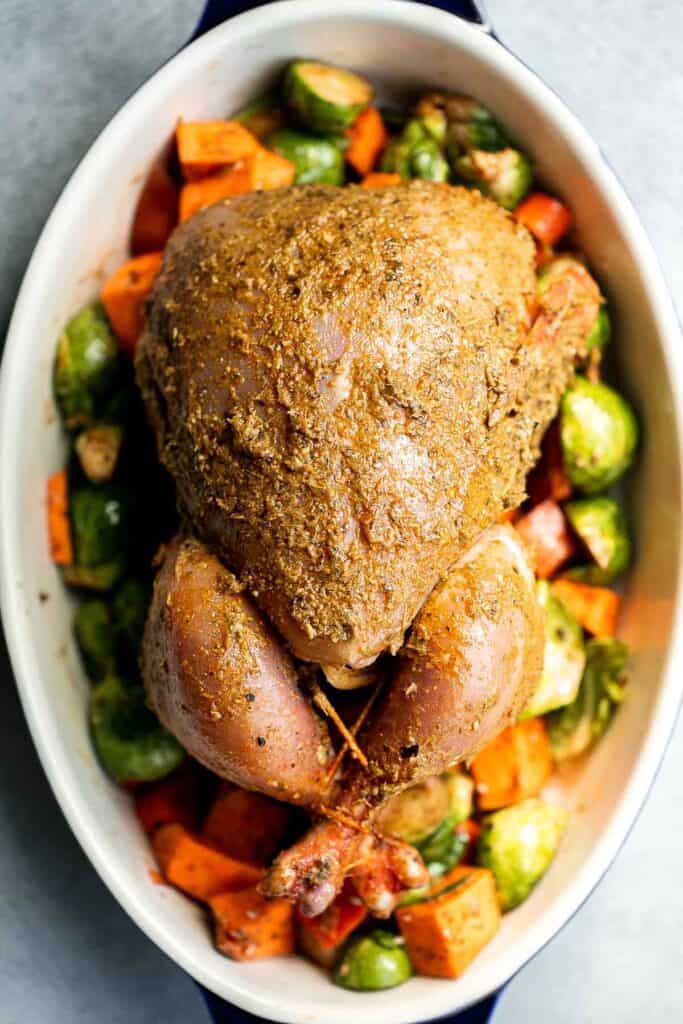 Pesto Roast Chicken is juicy, flavorful, and roasted with basil pesto over vegetables for an easy, one-pan dinner everyone loves. | aheadofthyme.com