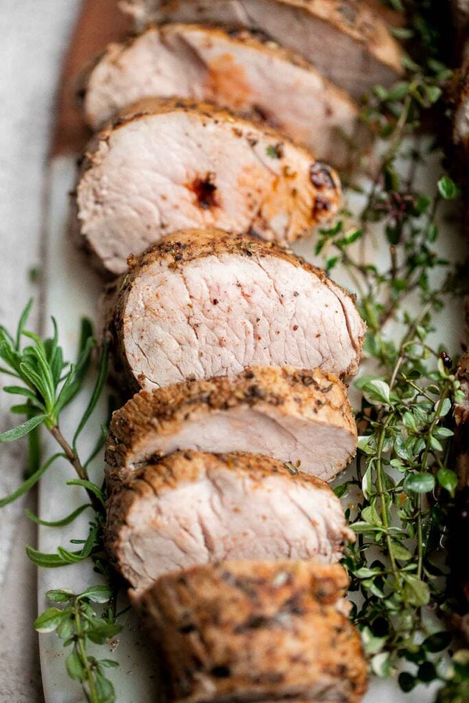 Quick easy roasted pork tenderloin with sauce is juicy, tender, and flavorful. Ready in 30 minutes, it's perfect for busy weeknights or a holiday dinner. | aheadofthyme.com