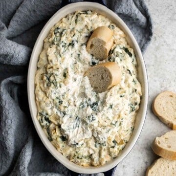 This baked spinach artichoke dip is quick, easy, creamy, flavorful, and delicious. This warm dip is baked in the oven and served with bread or crackers. | aheadofthyme.com