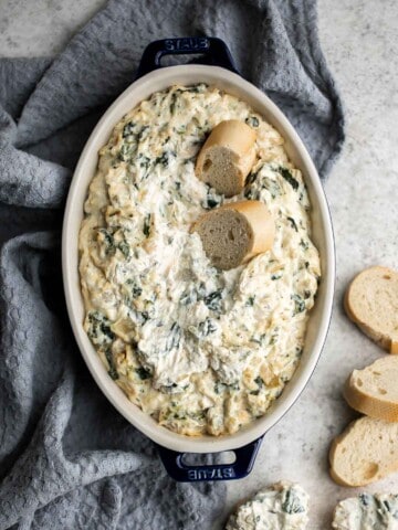 This baked spinach artichoke dip is quick, easy, creamy, flavorful, and delicious. This warm dip is baked in the oven and served with bread or crackers. | aheadofthyme.com