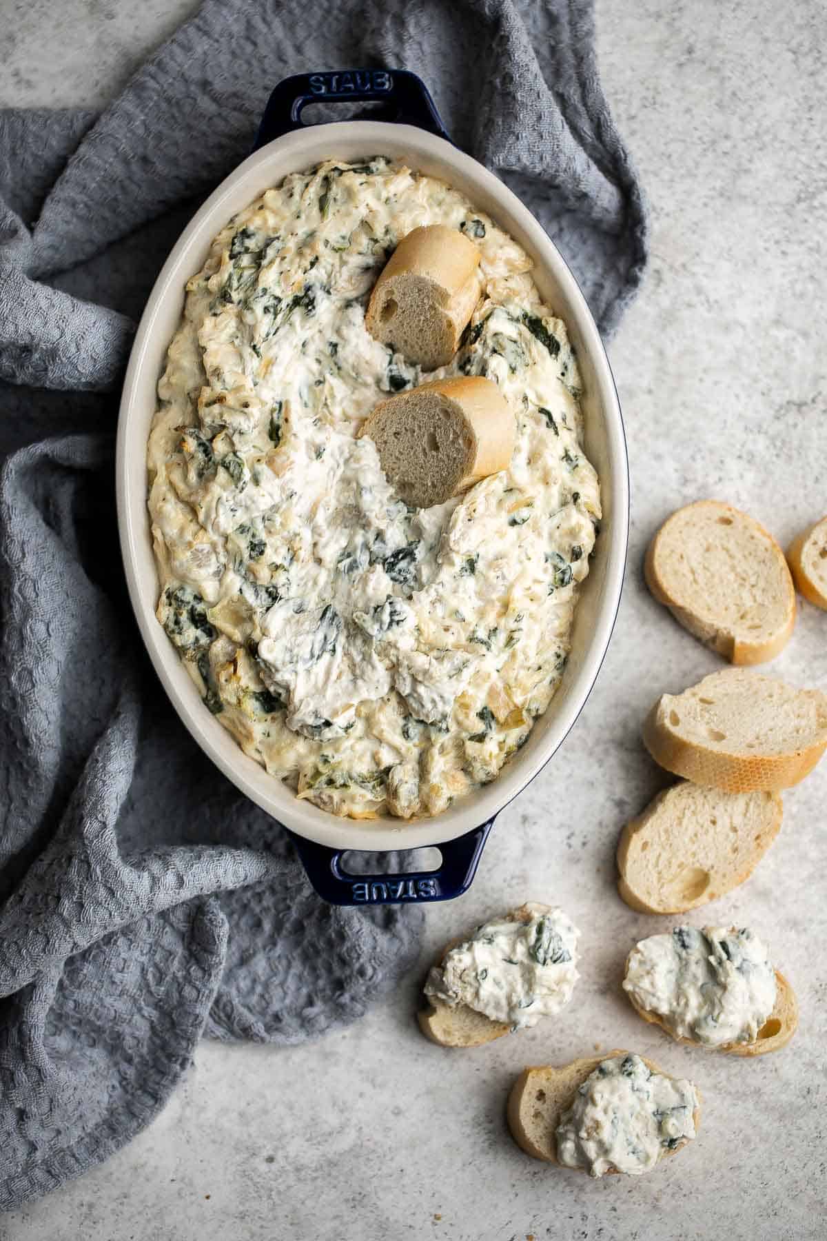 This baked spinach artichoke dip is quick, easy, creamy, flavorful, and delicious. This warm dip is baked in the oven and served with bread or crackers. | aheadofthyme.com