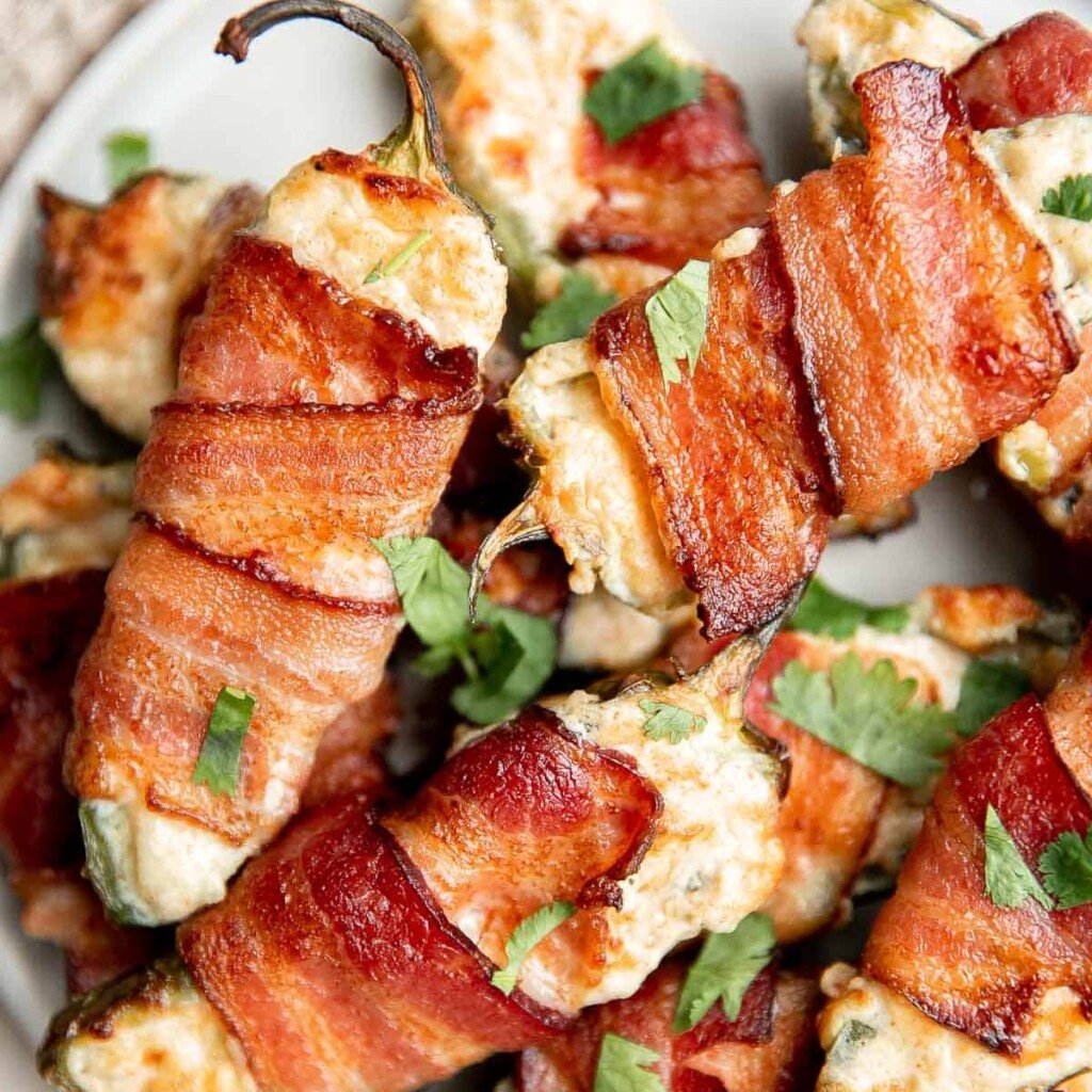 Bacon wrapped jalapeño poppers are crispy on the outside, creamy and cheesy inside, spicy, and wrapped in bacon. Easy to make in the air fryer or oven. | aheadofthyme.com