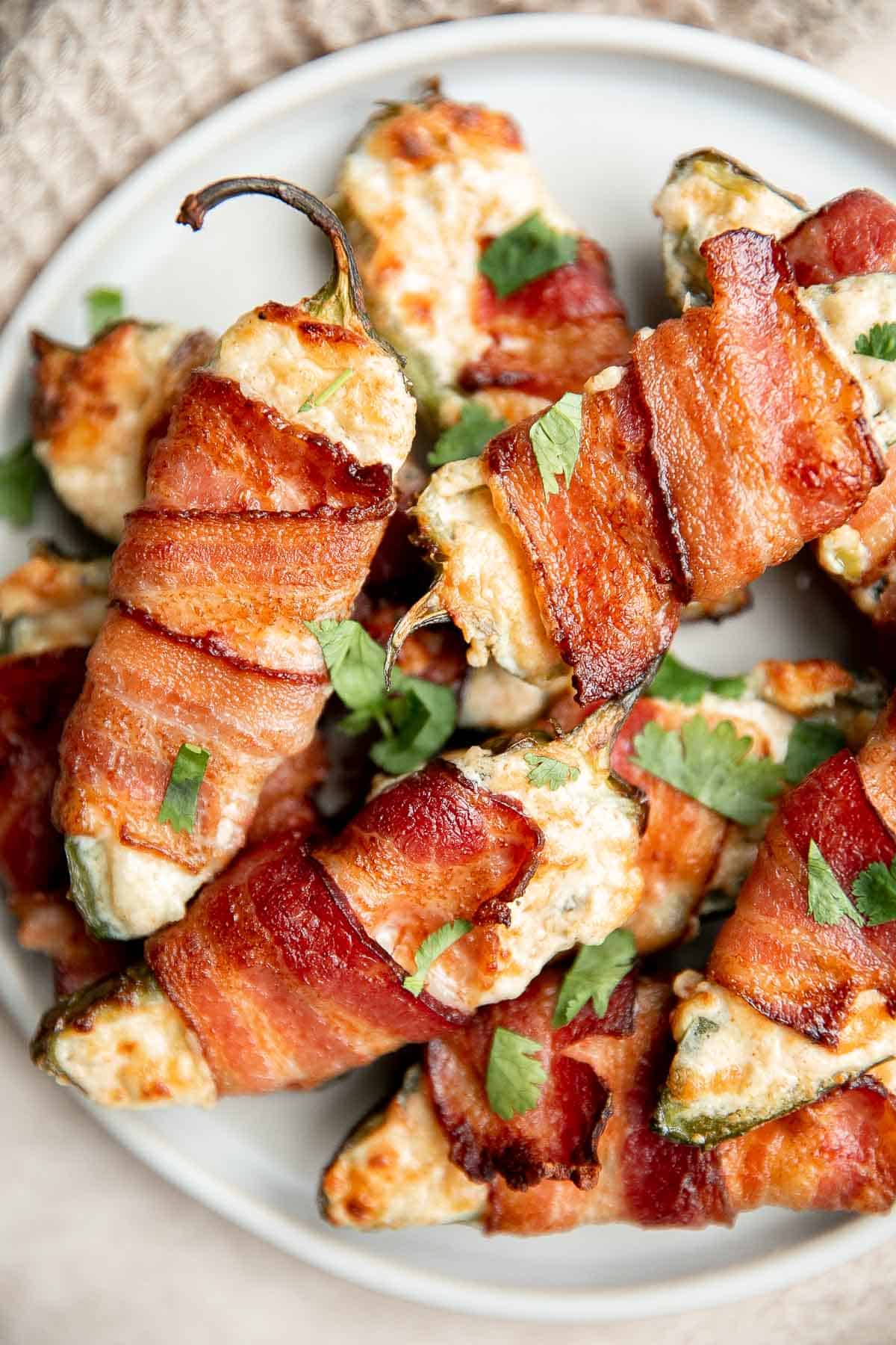 Bacon wrapped jalapeño poppers are crispy on the outside, creamy and cheesy inside, spicy, and wrapped in bacon. Easy to make in the air fryer or oven. | aheadofthyme.com