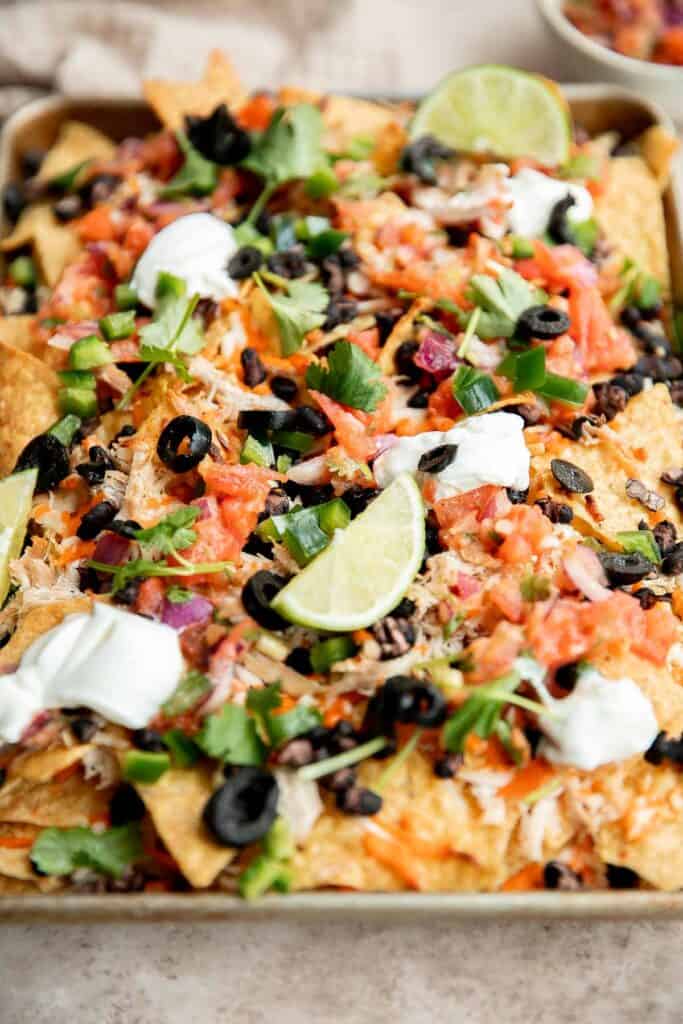 Chicken nachos are an easy to make when you’re craving something filling, crunchy, cheesy, and satisfying. Perfect game day appetizer or late-night snack. | aheadofthyme.com