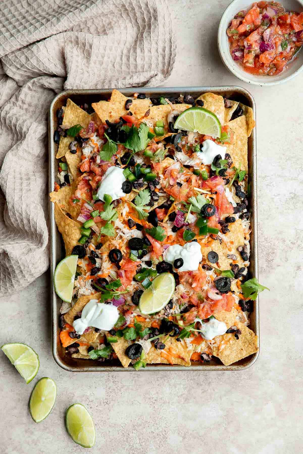 Chicken nachos are an easy to make when you’re craving something filling, crunchy, cheesy, and satisfying. Perfect game day appetizer or late-night snack. | aheadofthyme.com