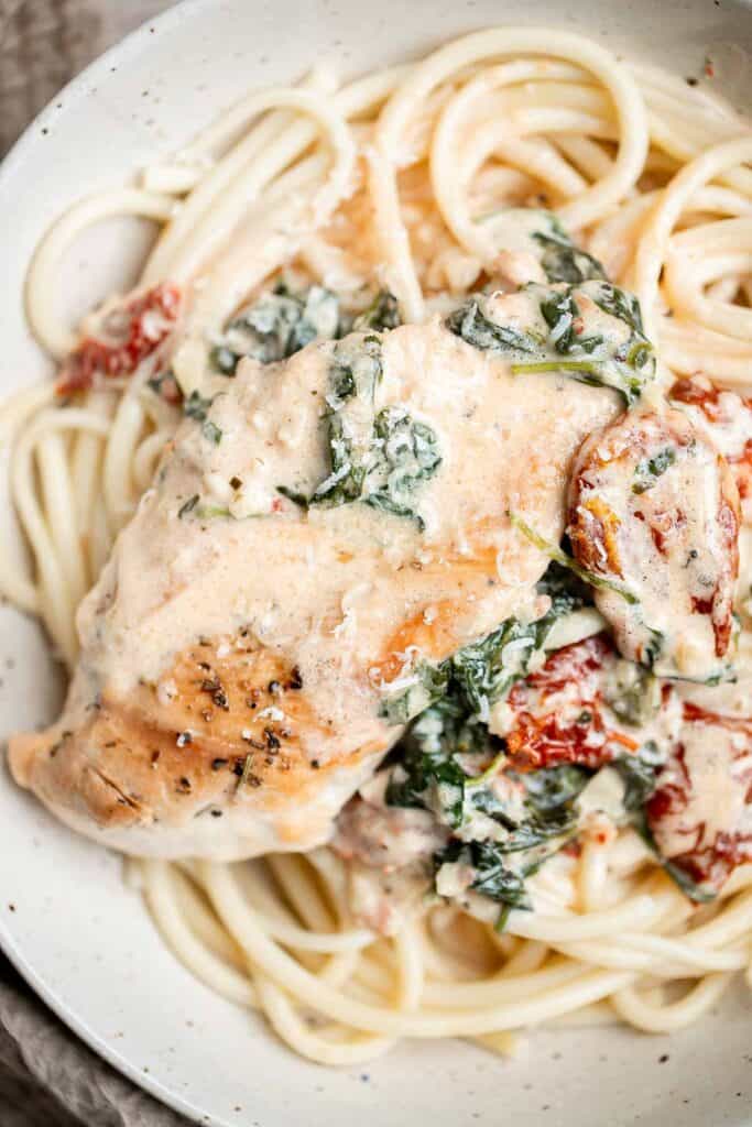 Creamy Tuscan chicken with sun-dried tomatoes and spinach is a quick and easy 30 minute Italian chicken dinner that is delicious, flavorful, and comforting. | aheadofthyme.com