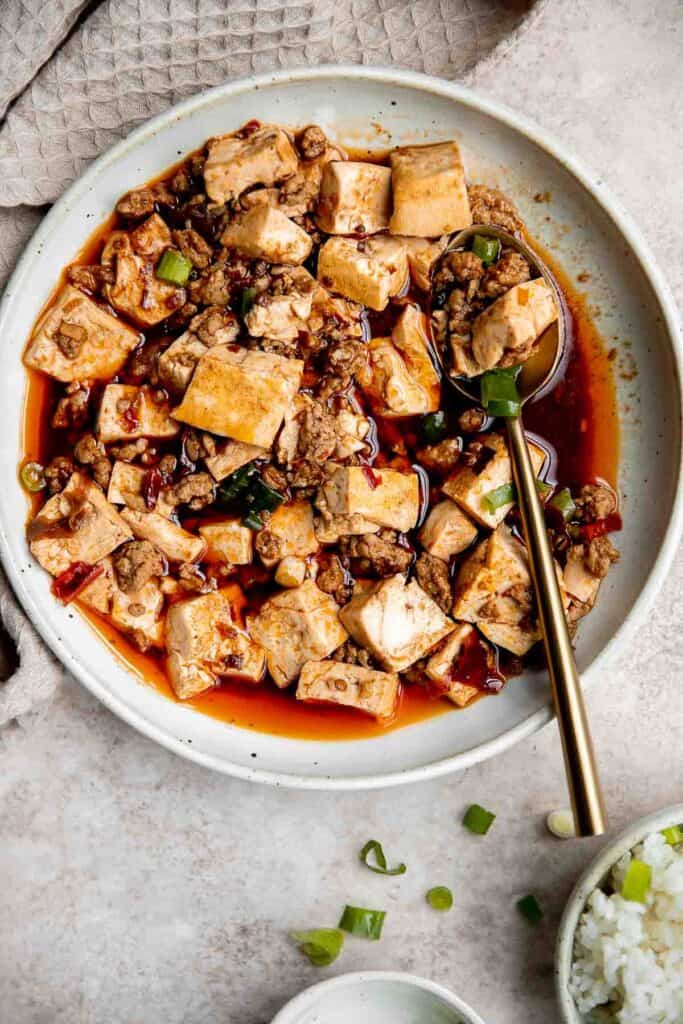 Mapo tofu is quick, easy, delicious, flavorful, spicy, and numbing that is ready in just 20 minutes. Serve it with steamed rice on busy weeknights. | aheadofthyme.com