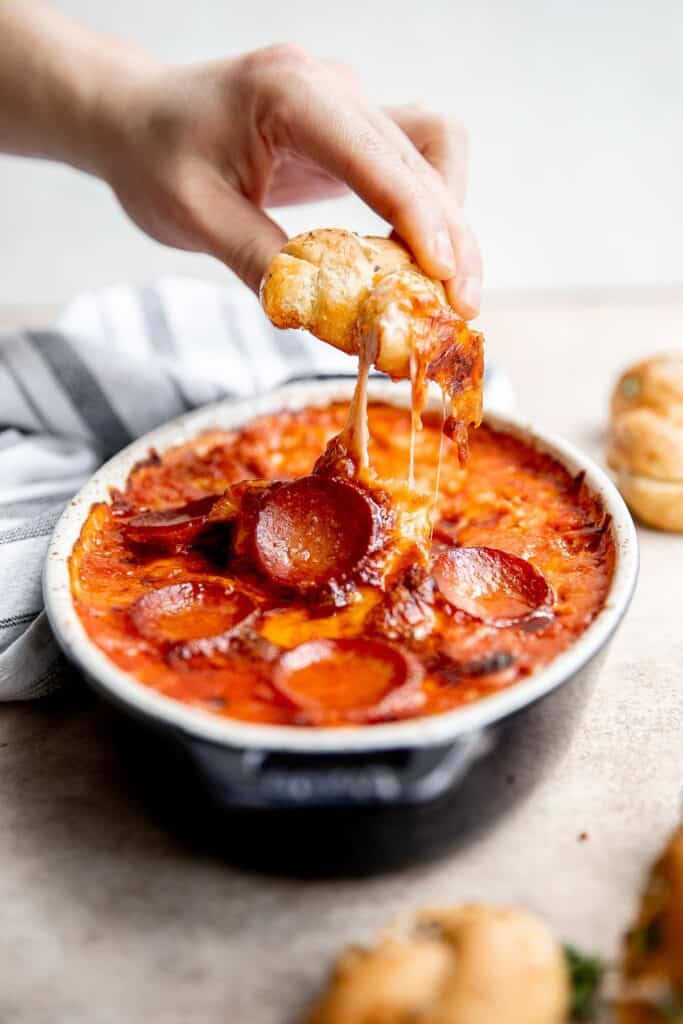 Pepperoni pizza dip is creamy, rich, comforting, and delicious. This appetizer is easy to make, easy to prepare ahead of time, and easy to eat. | aheadofthyme.com