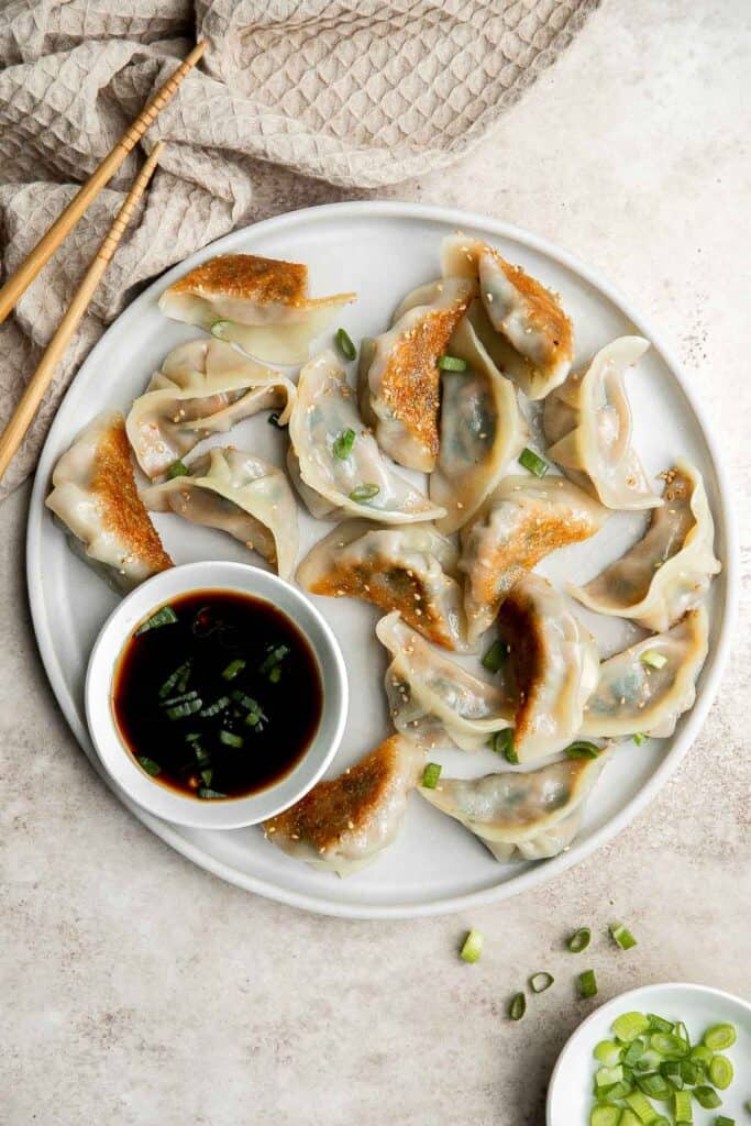 Homemade pork dumplings are quick and easy to make, with perfect crispy bottoms and a tender, juicy pork filling inside.​ Easy to meal prep and freeze well. | aheadofthyme.com