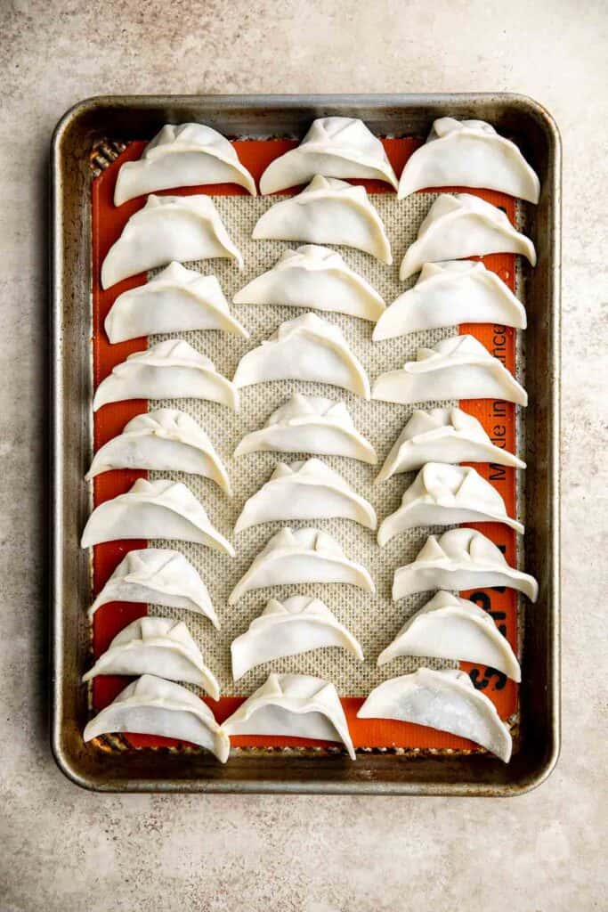 Homemade pork dumplings are quick and easy to make, with perfect crispy bottoms and a tender, juicy pork filling inside.​ Easy to meal prep and freeze well. | aheadofthyme.com