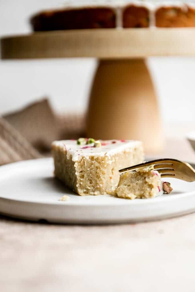 Persian Love Cake is a rich, moist, and nutty almond cake loaded with floral and citrus flavors, topped with a lemon glaze, pistachios, and rose petals. | aheadofthyme.com