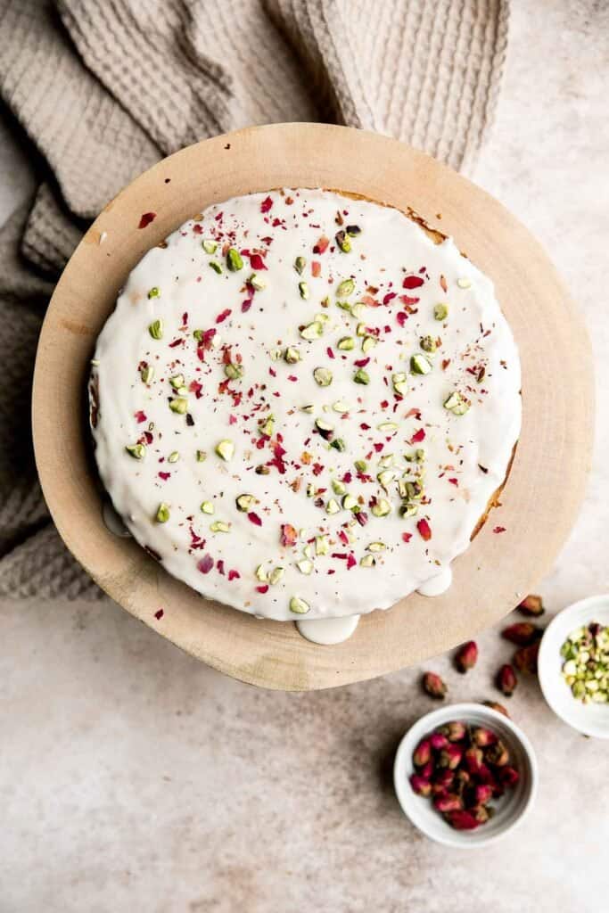 Persian Love Cake is a rich, moist, and nutty almond cake loaded with floral and citrus flavors, topped with a lemon glaze, pistachios, and rose petals. | aheadofthyme.com